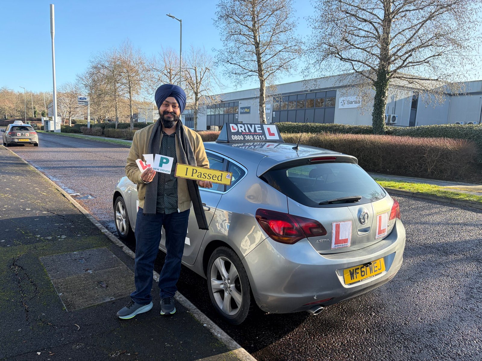 Gurpreet standing beside a JM Drive car after passing